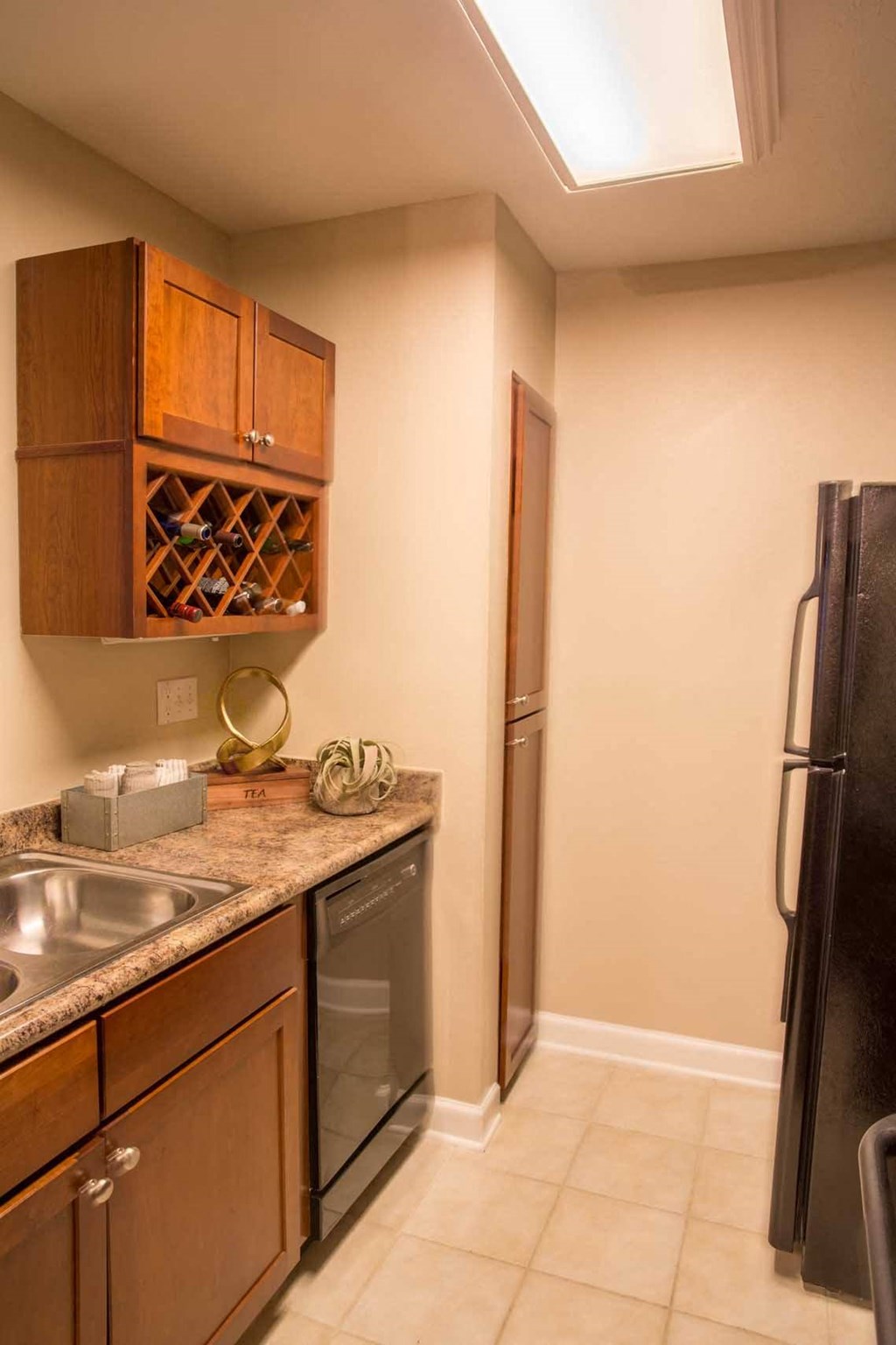 a kitchen with a sink and a refrigerator