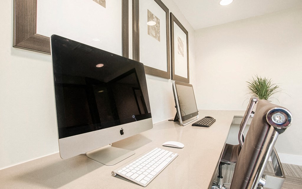 a desk with a computer on it in a room