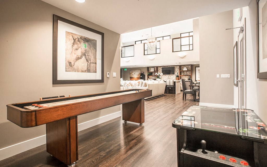 a game room with a pool table and a bar