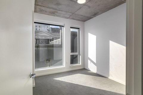 a living room with a large window and a white door