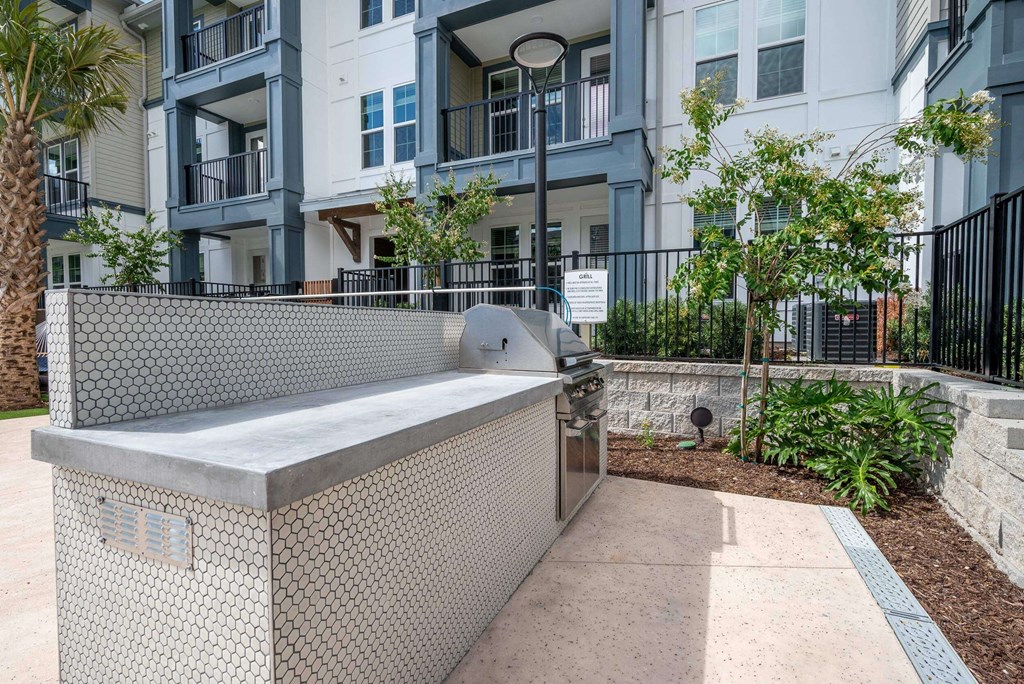 an outdoor hot tub with an apartment building in the background