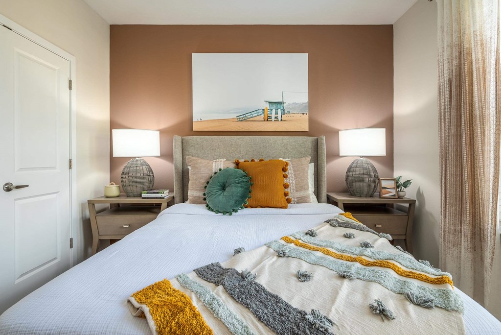 a bedroom with a bed and a painting on the wall