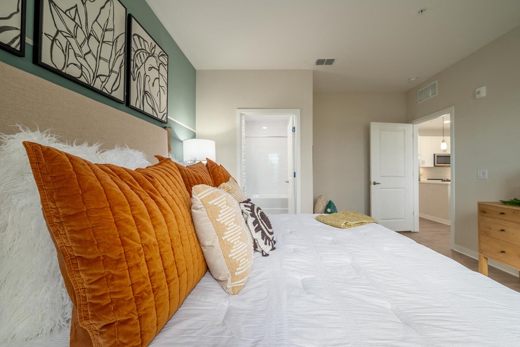 a bedroom with a large white bed with pillows
