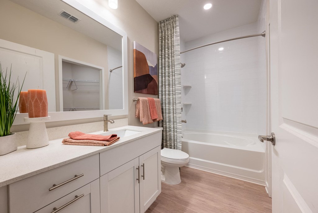 a bathroom with a shower and a sink and a toilet