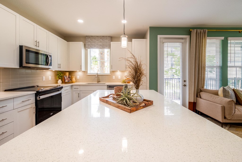 a kitchen with a large white counter top