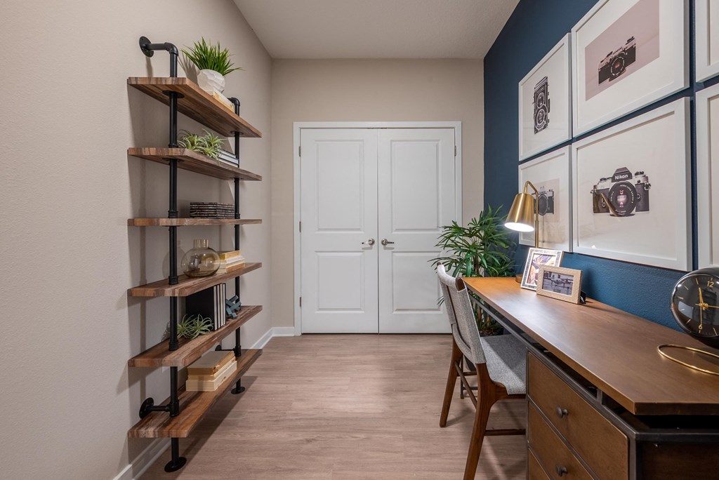 a home office with a desk and a door