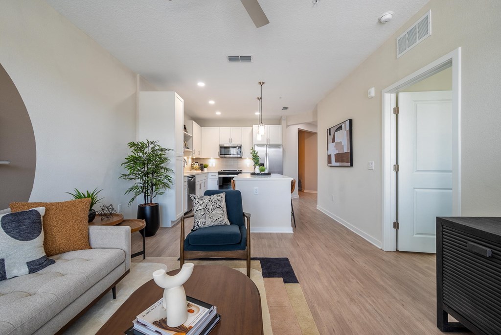 a living room and kitchen with a couch and a table