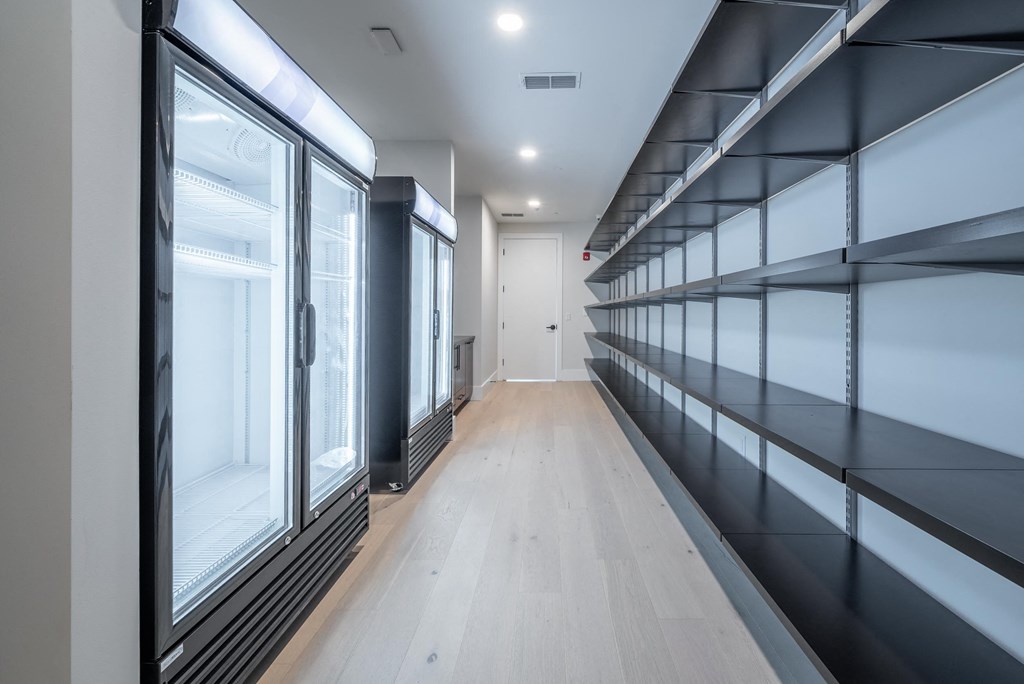 a hallway with glass windows and a wood floor