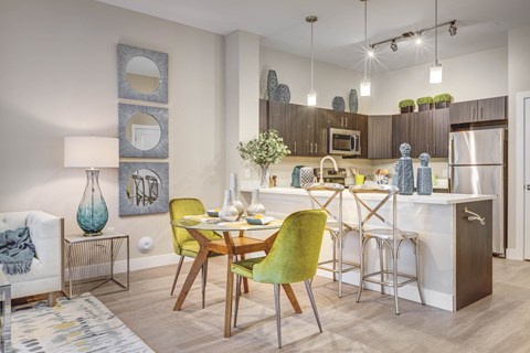 A modern kitchen with a dining table and chairs.