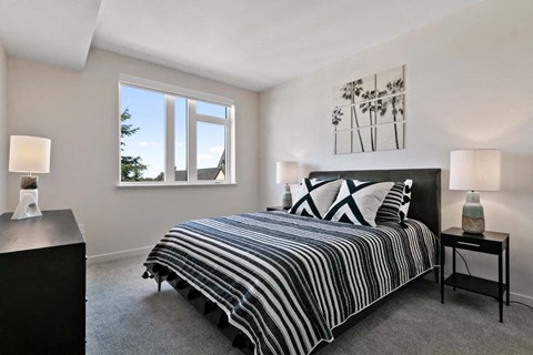 a bedroom with a bed and a window