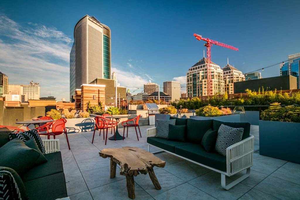 a city skyline with a reflection of buildings and a crane