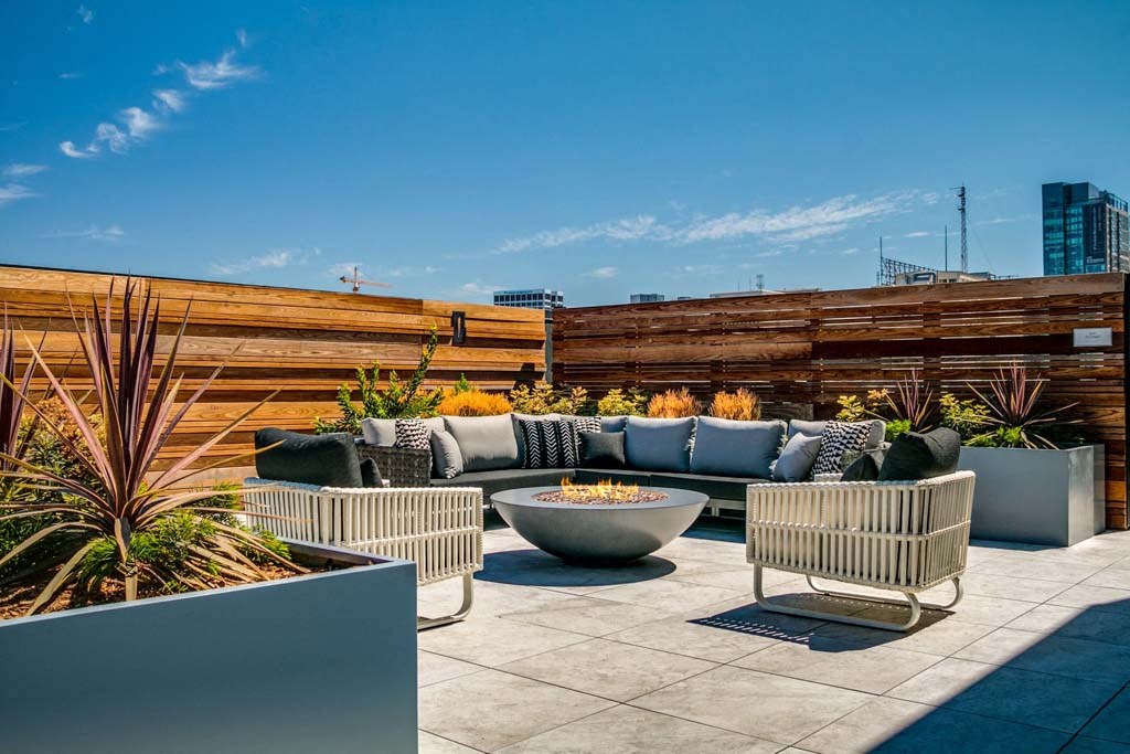a terrace with couches and chairs on a roof