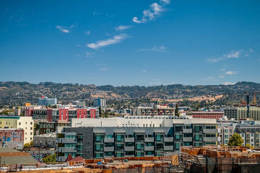a city with buildings and mountains in the background