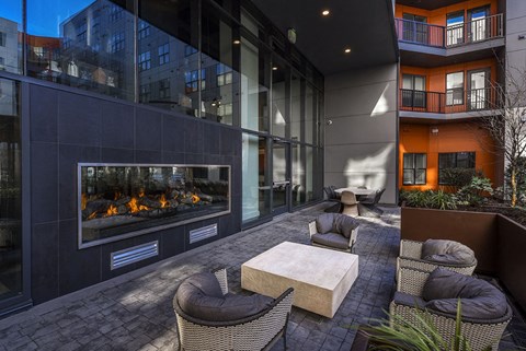 a room with a table and chairs and a window with a reflection of a building