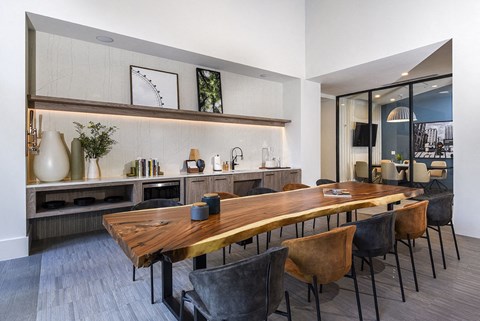 a dining room with a wooden table and chairs