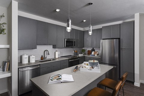 a kitchen with stainless steel appliances and gray cabinets