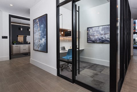 a conference room with a desk and sliding glass doors