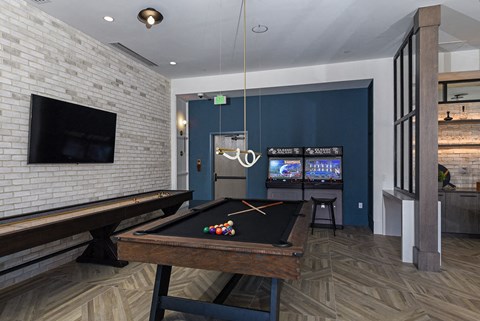 a game room with a pool table and a television