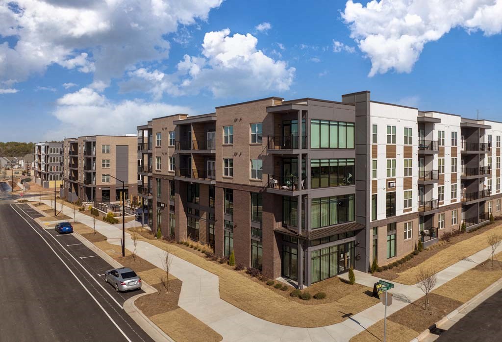 a rendering of a new apartment building on a city street