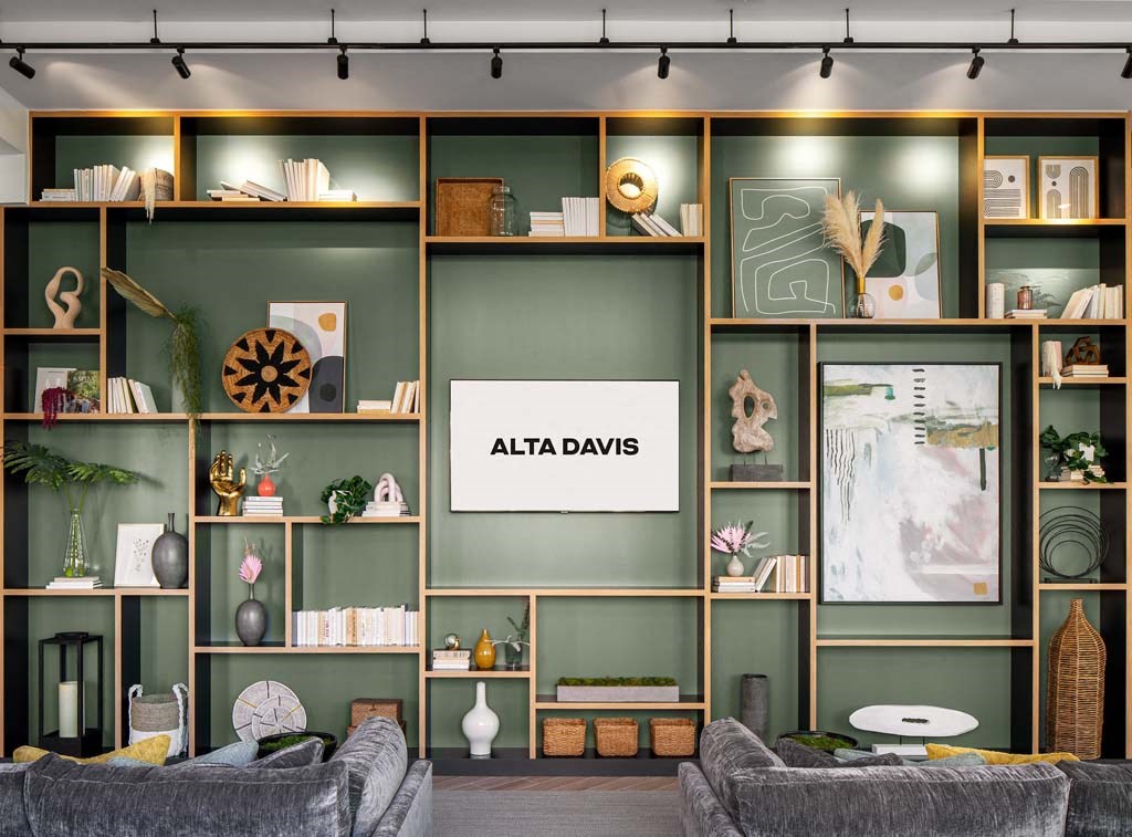 a living room filled with furniture and a wall of shelves