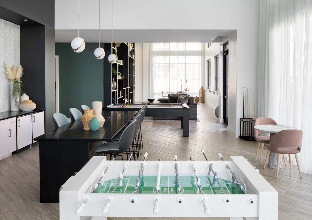 a living room and dining room with a pool in the middle