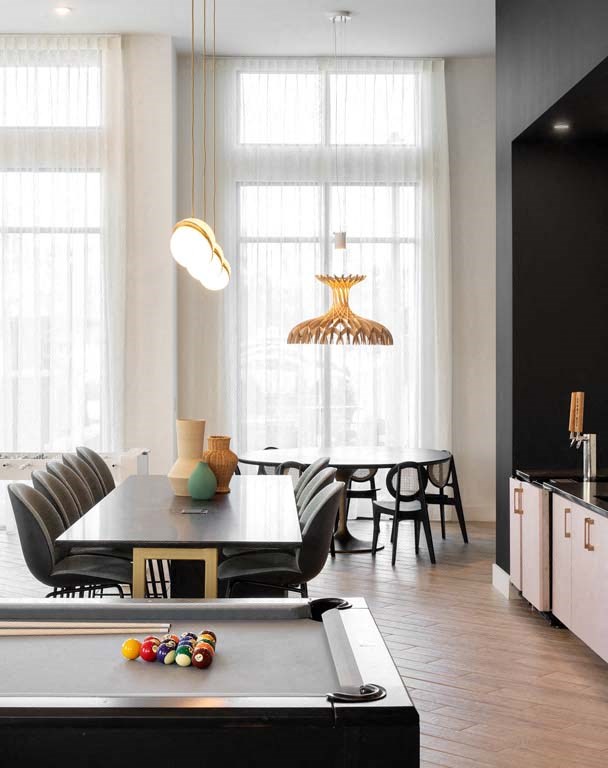 a dining room with a table and chairs and a pool table