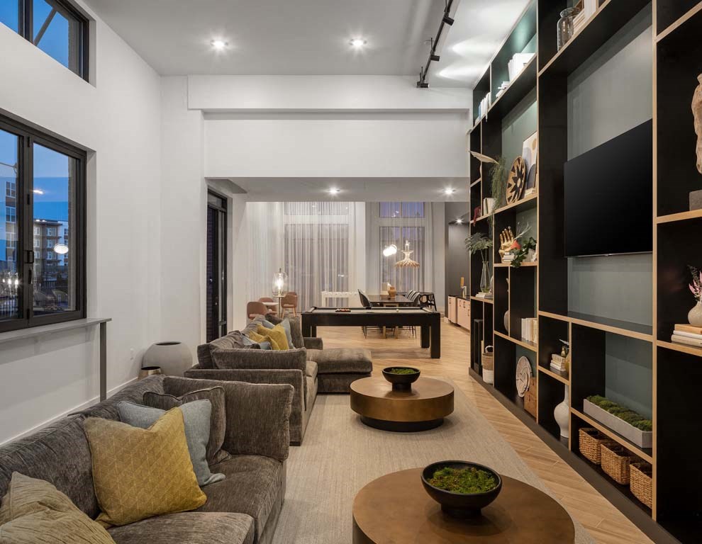 a living room filled with furniture and a large window