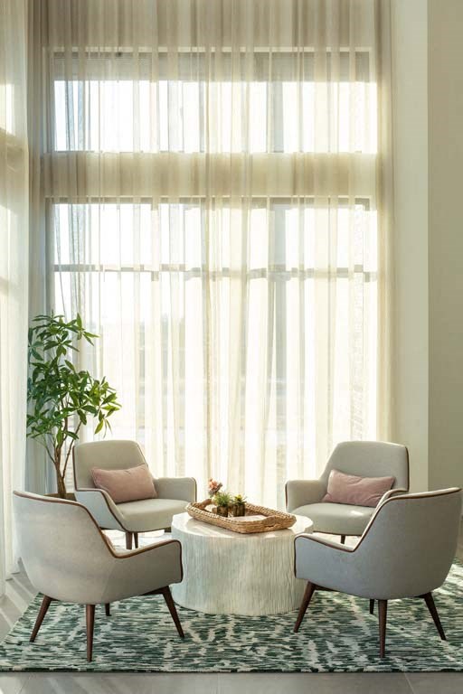 a living room with two chairs and a table