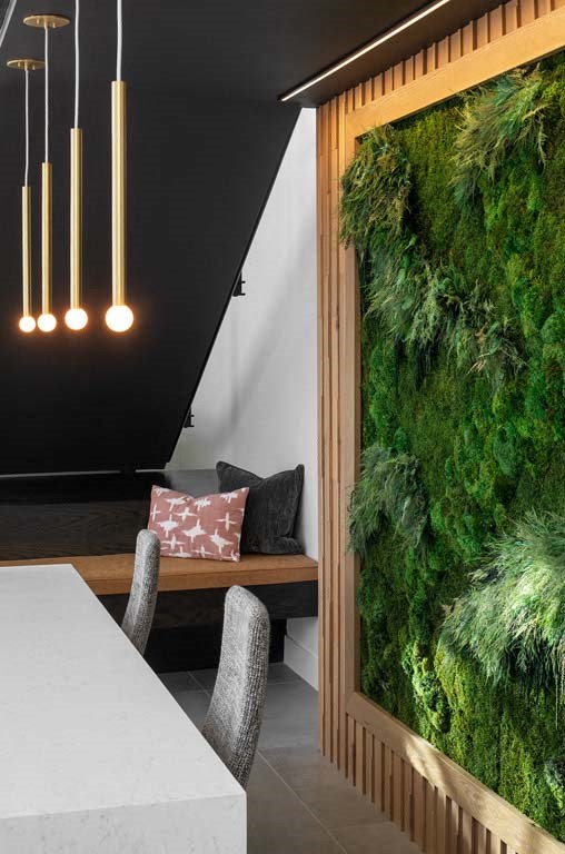 a living wall in a dining room next to a table