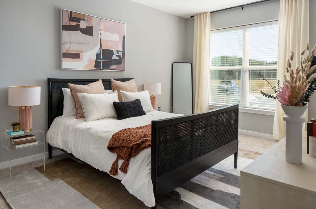 a bedroom with a bed and a large window