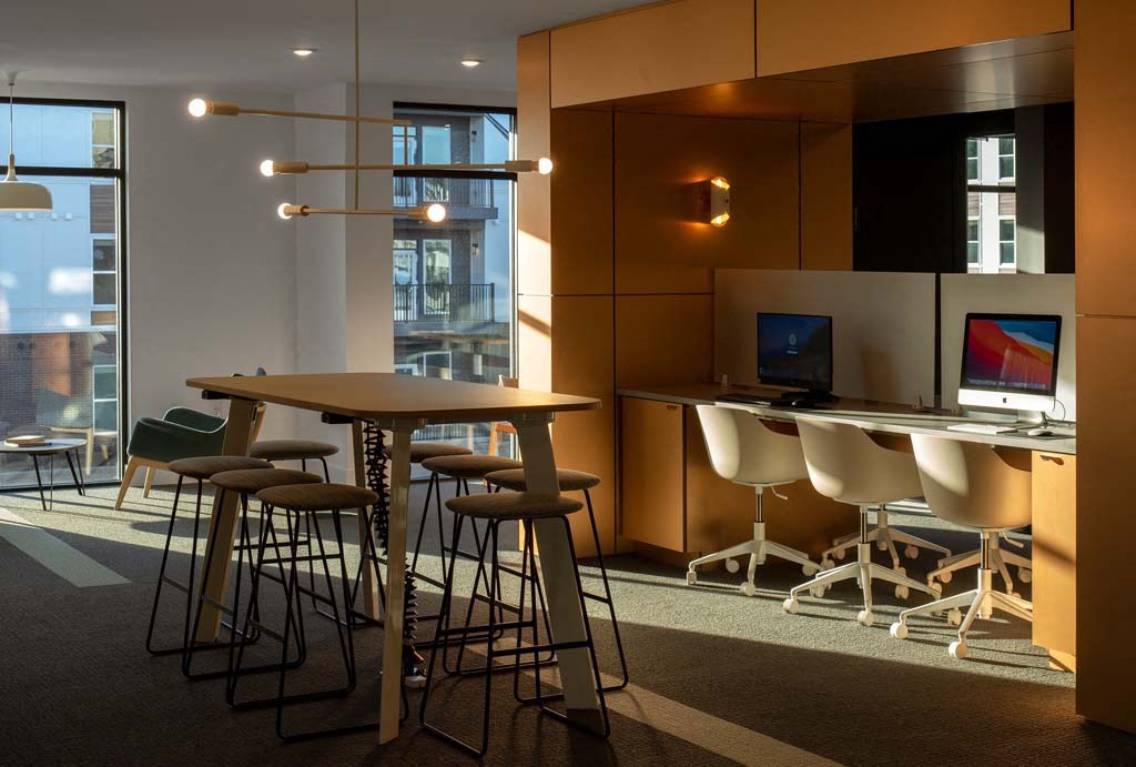 a room with a table and chairs and a computer