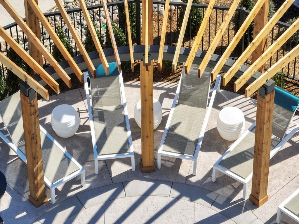 a group of chairs sitting under a wooden structure