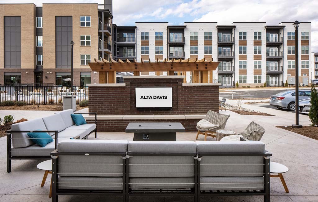 a seating area with furniture in front of an apartment building