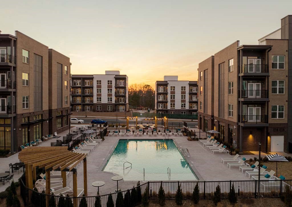 a view of a swimming pool in front of some apartment buildings