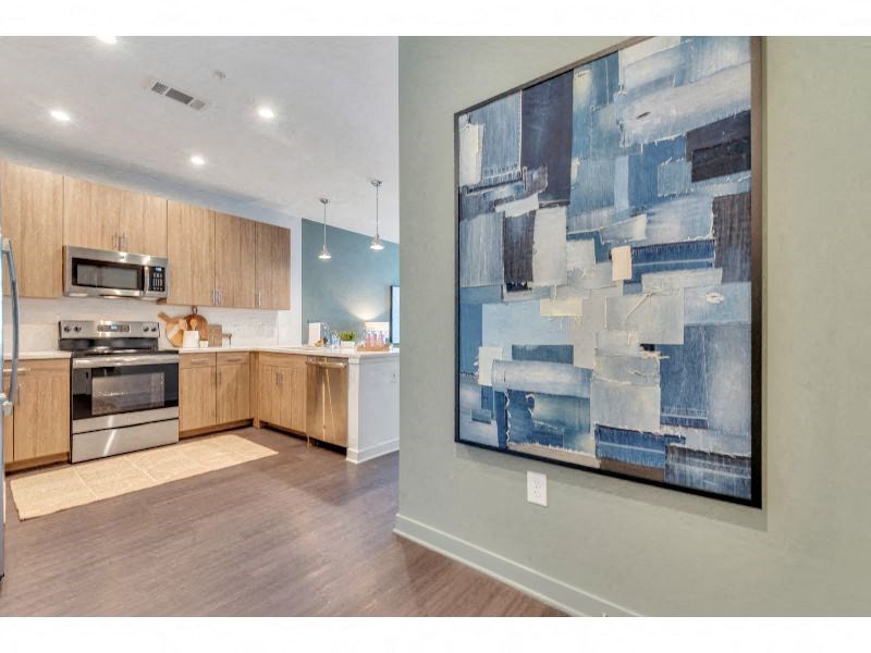 a painting hanging in a kitchen next to a