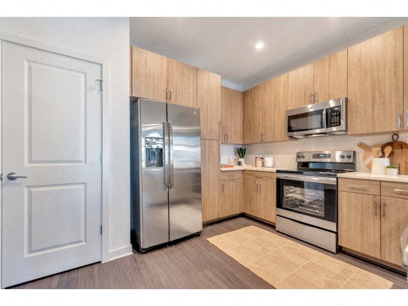 a kitchen with stainless steel appliances and wooden cabinets
