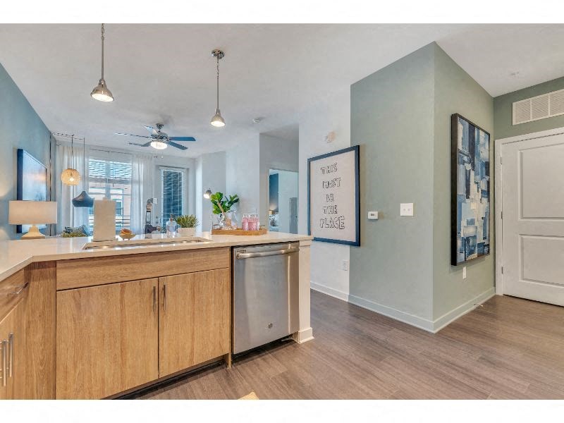a kitchen with an island and a ceiling fan