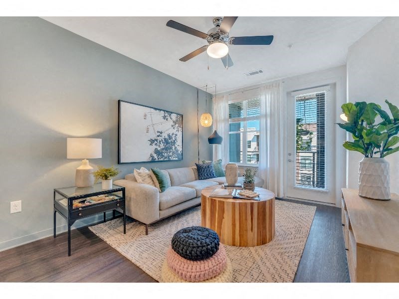 a living room with a couch and a ceiling fan