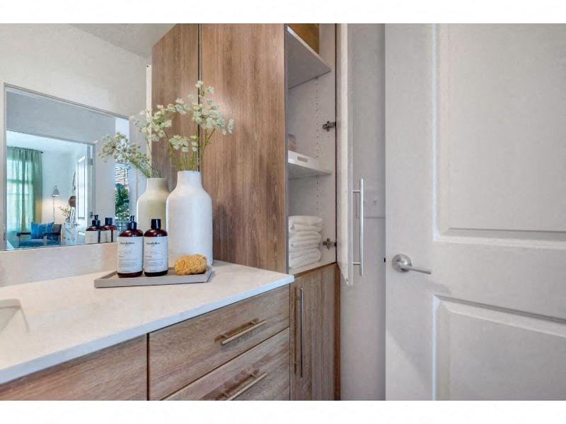 a bathroom with wooden cabinets and a white door