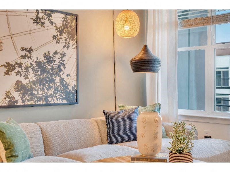 a living room with a couch and a lamp and a window