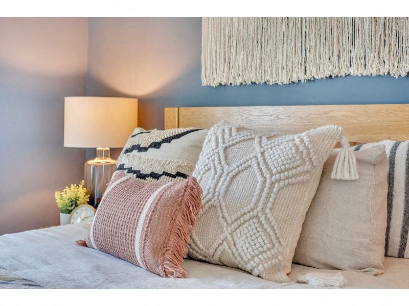 a bed with pillows and a blanket on it