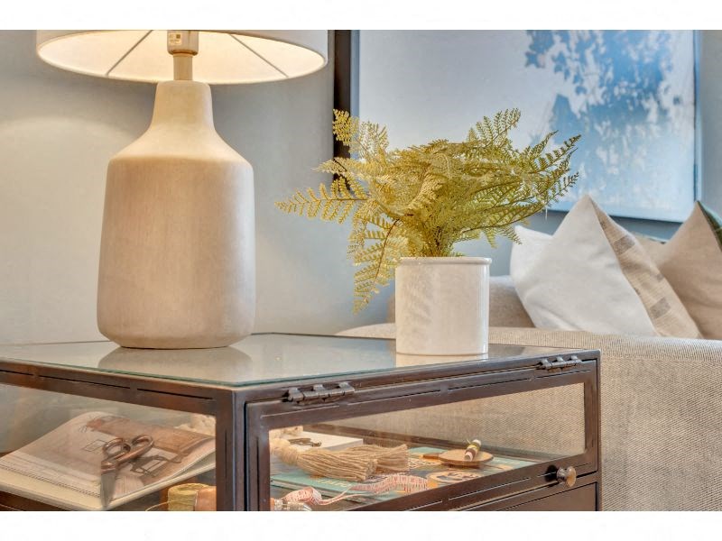 a table with a vase and a lamp on it