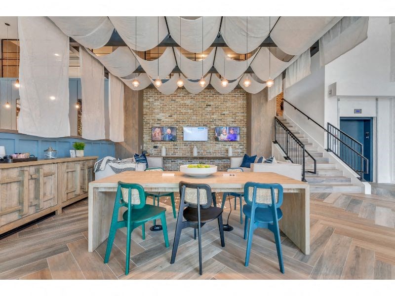 a large dining room with a table and chairs