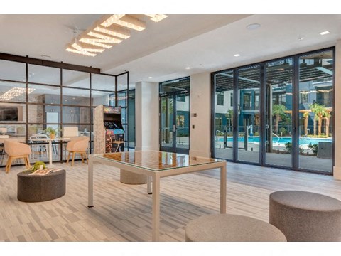 a lobby with a table and chairs and a pool