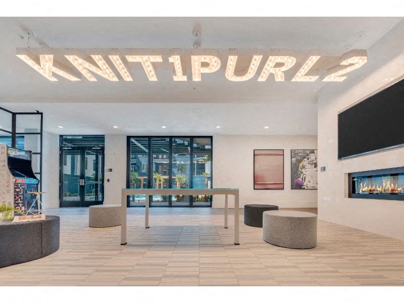 a large lobby with a table and a fireplace