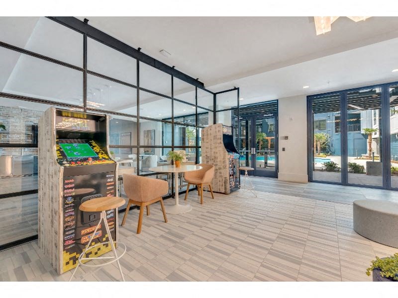 a game room with a foosball table and chairs