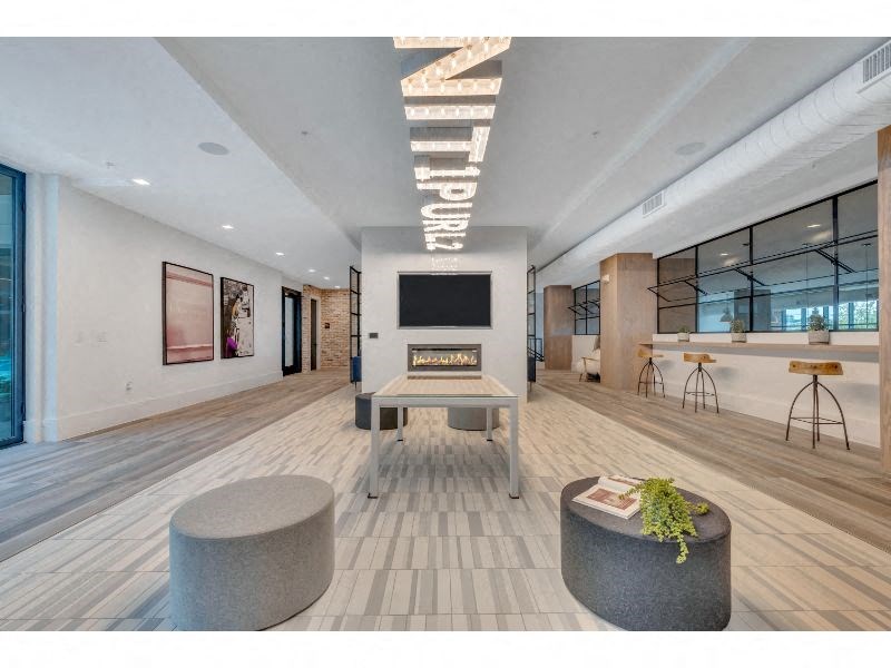 a large living room with a fireplace and a table