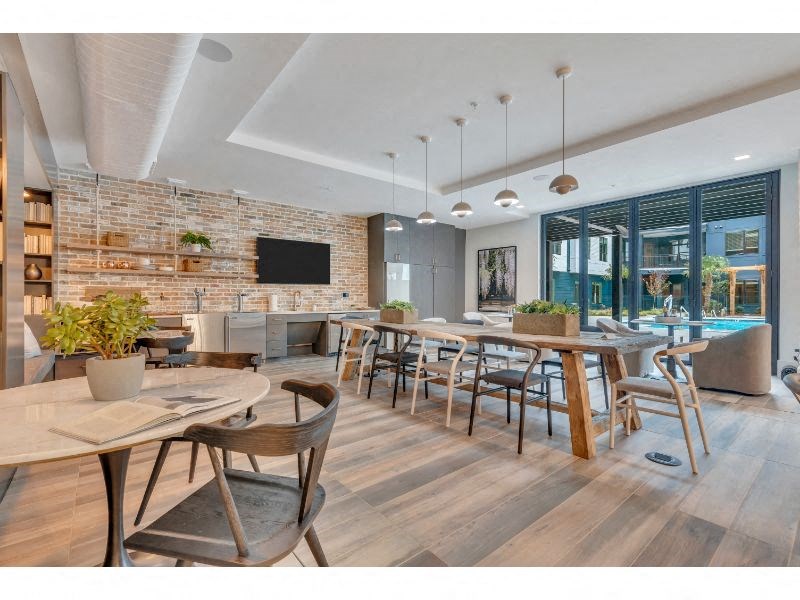 a restaurant with tables and chairs and a living room with a pool