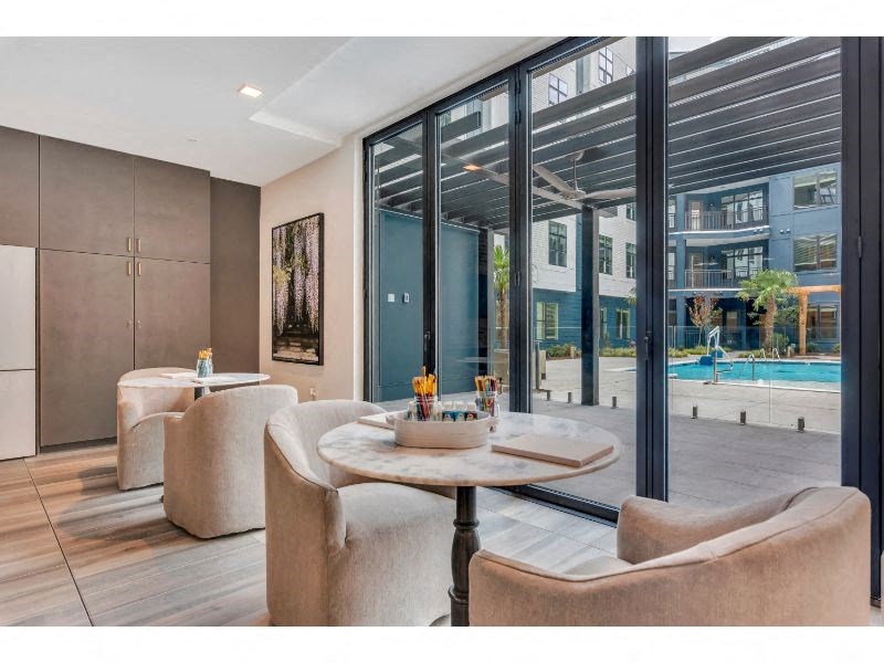 a living room with chairs and a table and a pool