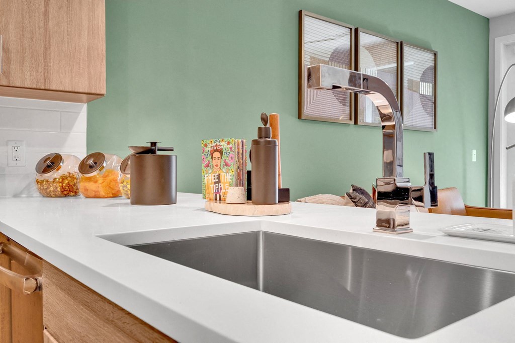 a kitchen counter with a sink and a faucet